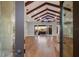 Spacious living room featuring vaulted ceilings, wood beams, and access to an outdoor patio at 875 Siesta Key Cir, Sarasota, FL 34242