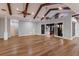 Spacious living room with wood floors, beamed ceiling, and sliding doors to an outdoor space at 875 Siesta Key Cir, Sarasota, FL 34242