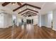 Expansive living room features hardwood floors, beamed ceilings, and generous space for gathering and relaxing at 875 Siesta Key Cir, Sarasota, FL 34242