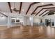Open living room and kitchen showcases wood floors, ceiling beams, and a seamless flow, ideal for modern living at 875 Siesta Key Cir, Sarasota, FL 34242