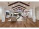 Living room with wooden floors, ceiling beams, and stylish furnishings; natural light enhances the modern decor at 875 Siesta Key Cir, Sarasota, FL 34242