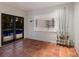 A spacious room with tiled flooring, a mounted fishing rod display, and doors leading out to the pool area at 875 Siesta Key Cir, Sarasota, FL 34242