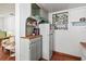 Bright kitchen area with white cabinets and stainless steel appliances, with a view into the next room at 919 N Osprey Ave, Sarasota, FL 34236