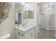 Bright bathroom features a white vanity with storage and modern fixtures, enhanced by stylish decorative accents at 11200 Mcdermott Ct, Englewood, FL 34223