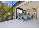View of the outdoor lanai and chairs leading to an interior view at 11200 Mcdermott Ct, Englewood, FL 34223