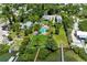 High aerial view of large property with pool, mature trees, and dock, offering a private waterfront oasis at 12204 45Th Avenue W Dr, Cortez, FL 34215
