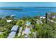 Stunning aerial view of a coastal home with a pool, dock, and picturesque waterfront scenery at 12204 45Th Avenue W Dr, Cortez, FL 34215