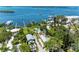 Aerial view of a waterfront property featuring manicured grounds, a pool, and a boat dock with ocean access at 12204 45Th Avenue W Dr, Cortez, FL 34215