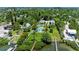 Expansive aerial view highlighting the estate with pool, mature trees, and waterfront access to the adjacent dock at 12204 45Th Avenue W Dr, Cortez, FL 34215