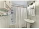Bathroom featuring white tile and a pedestal sink at 12204 45Th Avenue W Dr, Cortez, FL 34215