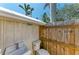 Small outdoor bathroom area with a toilet, sink and a wooden fence on the side at 12204 45Th Avenue W Dr, Cortez, FL 34215