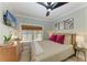 A bedroom with stylish decor, a TV, and natural light at 12204 45Th Avenue W Dr, Cortez, FL 34215