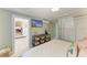 Bedroom showcasing an entertainment center, a view to another room, and a white closet at 12204 45Th Avenue W Dr, Cortez, FL 34215