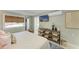 Cozy bedroom with TV, shelving, woven shade, and light walls at 12204 45Th Avenue W Dr, Cortez, FL 34215