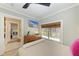 Stylish bedroom with TV, natural light, and view to hallway at 12204 45Th Avenue W Dr, Cortez, FL 34215