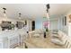Dining area open to kitchen, with seating for eight around a beautifully set wooden table at 12204 45Th Avenue W Dr, Cortez, FL 34215