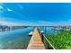 Picturesque waterfront view from the end of a wooden dock with boats and piers, perfect for marine enthusiasts at 12204 45Th Avenue W Dr, Cortez, FL 34215
