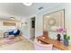 Bright home hallway with herringbone floors and view to the comfortable sitting room ahead at 12204 45Th Avenue W Dr, Cortez, FL 34215