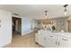 Open kitchen and dining area featuring herringbone floors, white cabinets, and stainless steel appliances at 12204 45Th Avenue W Dr, Cortez, FL 34215