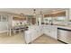 Bright kitchen and dining area featuring herringbone floors, white cabinets, and stainless steel appliances at 12204 45Th Avenue W Dr, Cortez, FL 34215