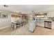 Open kitchen and dining area featuring herringbone floors, white cabinets, and an island with seating at 12204 45Th Avenue W Dr, Cortez, FL 34215