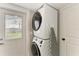 Bright laundry room featuring stacked washer and dryer at 12204 45Th Avenue W Dr, Cortez, FL 34215