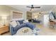 Inviting living room with stone fireplace, plush sofas, herringbone floors, and stylish ceiling fans at 12204 45Th Avenue W Dr, Cortez, FL 34215