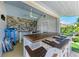 Close-up of the outdoor bar area featuring ample counter space, seating, and stylish finishes at 12204 45Th Avenue W Dr, Cortez, FL 34215