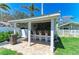 Outdoor bar area with seating and a brick-accented backsplash, perfect for entertaining in the backyard at 12204 45Th Avenue W Dr, Cortez, FL 34215