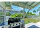 Covered outdoor grilling area featuring a stainless steel grill, ideal for outdoor cooking and entertaining at 12204 45Th Avenue W Dr, Cortez, FL 34215