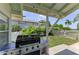 Covered outdoor grilling area featuring a stainless steel grill, ideal for outdoor cooking and entertaining at 12204 45Th Avenue W Dr, Cortez, FL 34215