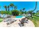 Relaxing poolside setting with lounge chairs, lush greenery, and a peaceful ambiance at 12204 45Th Avenue W Dr, Cortez, FL 34215