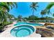 Beautiful in-ground pool with a spa, rock features, and brick surround, offering a luxurious outdoor experience at 12204 45Th Avenue W Dr, Cortez, FL 34215