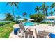 Picturesque poolside view showcasing lounge chairs, umbrellas, and a glimpse of the waterfront at 12204 45Th Avenue W Dr, Cortez, FL 34215