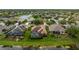 Aerial view of homes with screened in pools overlooking a tranquil lake and lush landscaping at 12211 Aster Ave, Bradenton, FL 34212