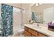 A well-lit bathroom with a shower/tub combo, a wooden vanity, and neutral walls at 12211 Aster Ave, Bradenton, FL 34212