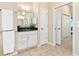 Well-lit bathroom with granite countertops, wood cabinets, and tile flooring at 12211 Aster Ave, Bradenton, FL 34212