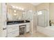 Bright bathroom featuring a large mirror, vanity, a glass shower, and neutral tones at 12211 Aster Ave, Bradenton, FL 34212