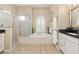 Bright bathroom featuring a large tub, a glass shower, and dual sink vanities at 12211 Aster Ave, Bradenton, FL 34212
