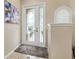 Elegant entryway with decorative glass door, neutral wall paint and tile flooring, creating a warm and welcoming atmosphere at 12211 Aster Ave, Bradenton, FL 34212