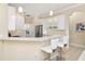 Modern kitchen featuring white cabinets, stainless steel appliances, and a breakfast bar with seating at 12211 Aster Ave, Bradenton, FL 34212