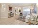 Cozy living area with tile floors, neutral walls, plush rug, and elegant furnishings in an open floorplan layout at 12211 Aster Ave, Bradenton, FL 34212