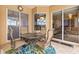 Cozy outdoor patio with table, chairs, and view of living area through sliding glass doors at 12211 Aster Ave, Bradenton, FL 34212
