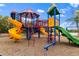 A colorful playground featuring multiple slides, climbing structures, and a swing set on a wood chip surface at 12211 Aster Ave, Bradenton, FL 34212