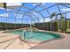 Stunning screened-in pool with spa, lush landscaping, and a serene backyard retreat at 12211 Aster Ave, Bradenton, FL 34212
