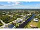 Expansive aerial view of a waterfront community offering beautiful landscaping and canal access at 12396 Bacchus Rd, Port Charlotte, FL 33981