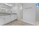 This bathroom features a double sink vanity with granite countertop and a large walk-in shower at 12396 Bacchus Rd, Port Charlotte, FL 33981