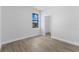 This bedroom features wood-look tile flooring, a window, and a door to the closet at 12396 Bacchus Rd, Port Charlotte, FL 33981