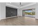 A spacious bedroom has tile floors, a tray ceiling with fan, and sliding glass doors to the pool at 12396 Bacchus Rd, Port Charlotte, FL 33981