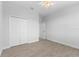 Clean, bright bedroom featuring wood-look tile flooring and a closet offering ample storage space at 12396 Bacchus Rd, Port Charlotte, FL 33981